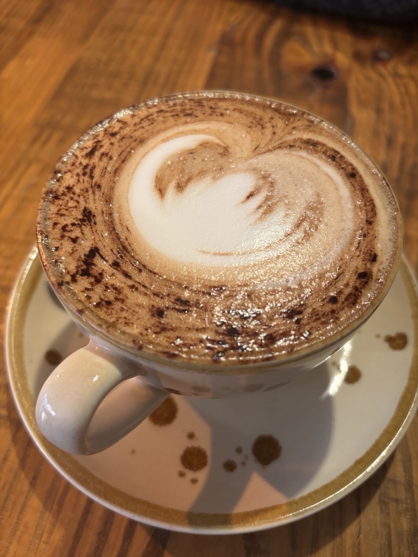 A cappuccino with latte art in a stoneware cup at La Bakerie, Wanstead